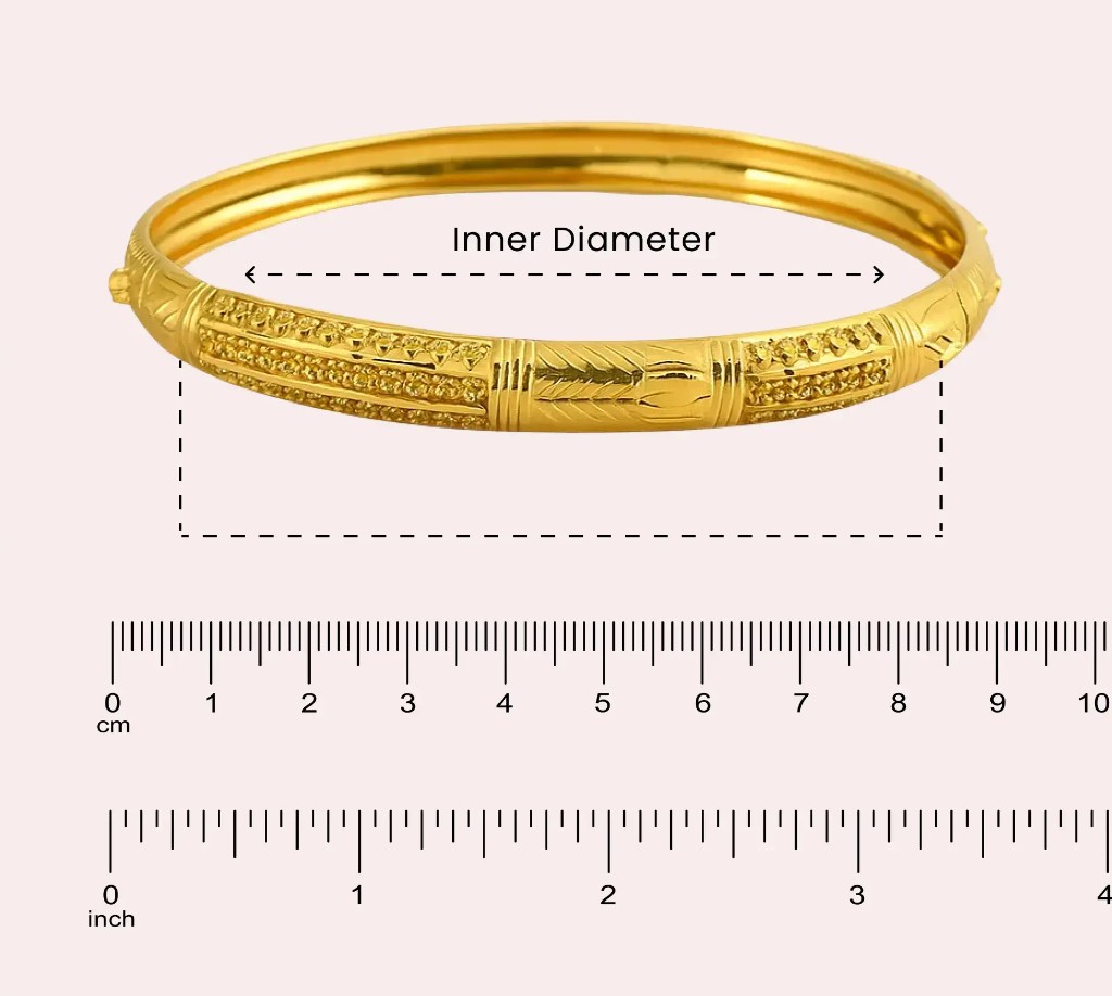 Gold bangle with inner diameter marked across cm and inch rulers
